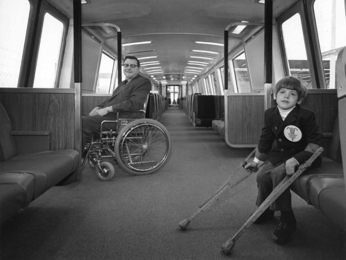 Harold Willson (left) smiles at Eric Staley (right) on a BART train in 1972. Photo courtesy of Kaiser Permanente Heritage Resources.