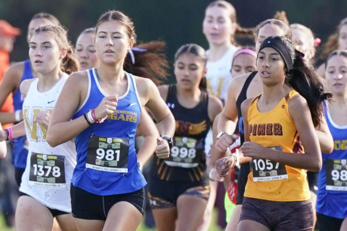 Cross County runners push through the mud towards the finish line