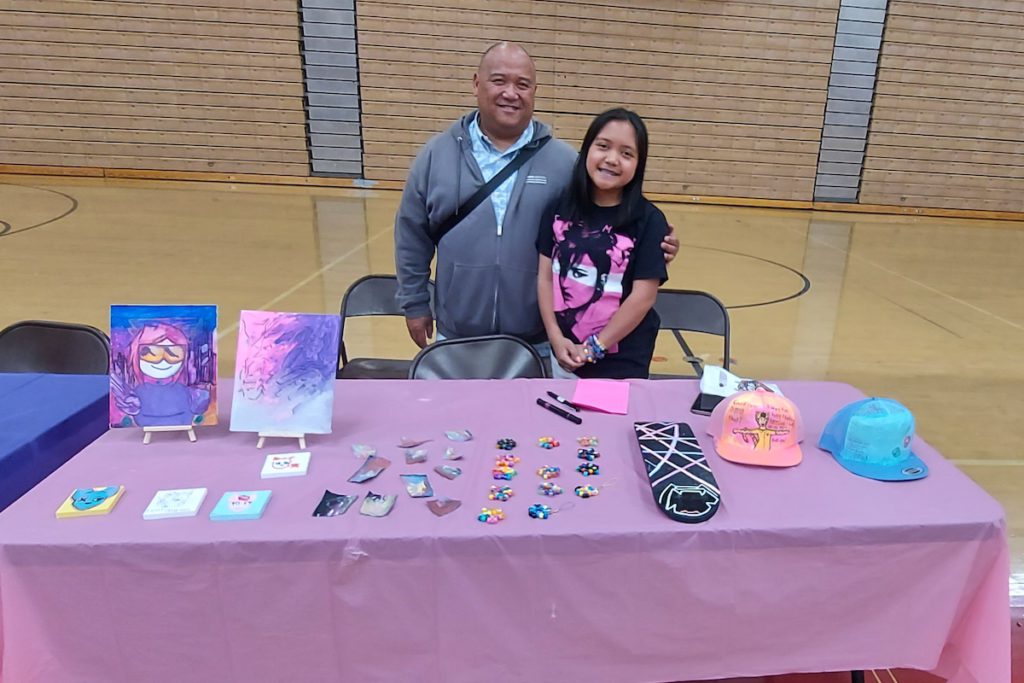 Artists like Addison Sierra (here with her proud father) learn how to interact with customers at the fair that concludes the program. Monika Lee