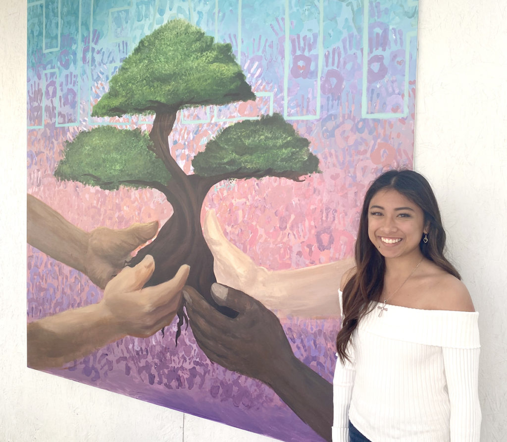 The Newark Memorial High School art department gave artist Julila Catancio a big hand for her painting—in the form of a background of individual hand prints. Stephanie Uchida