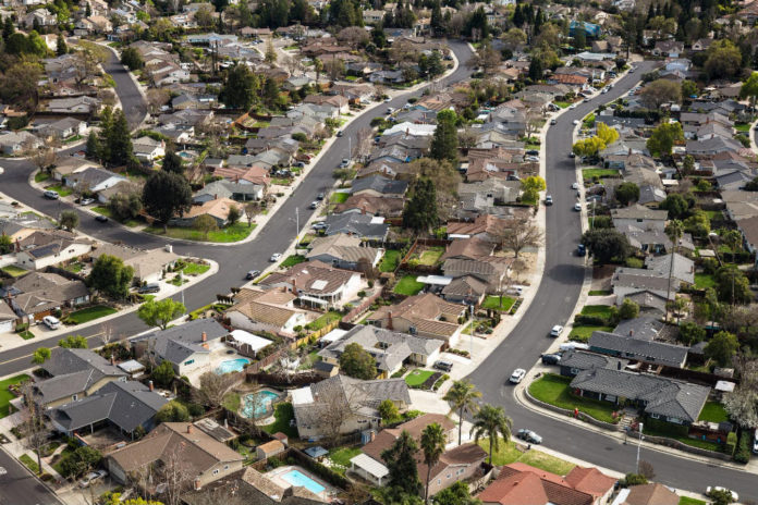 Aerial shot of suburban houses in Pleasanton, a city in Alameda County, California on an overcast day.