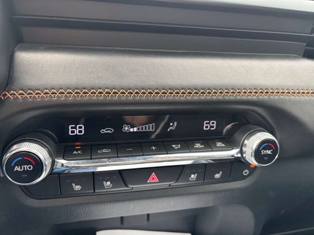 The interior features black leather seats with classy brown top-stitching. Michael Coates