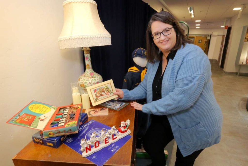 Museum Executive Director Diane Curry poses with nostalgic Christmas memorabilia.
Photos by Victor Carvellas