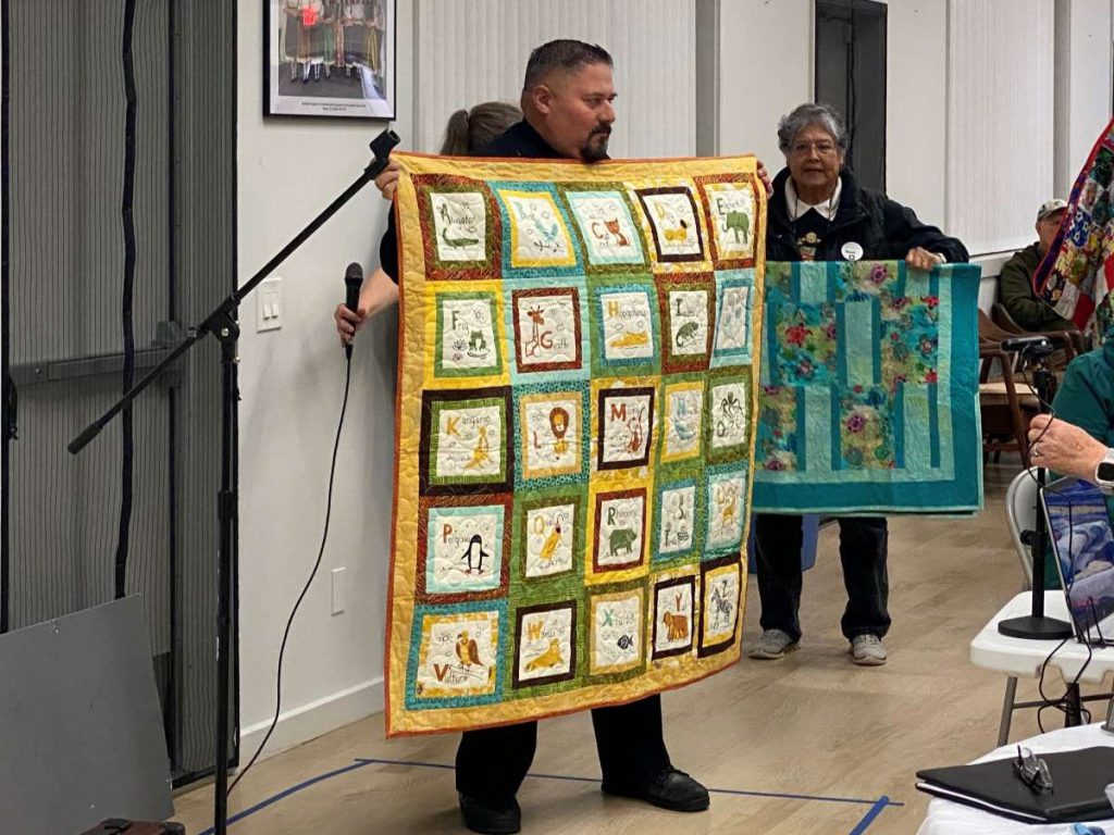 Salvador Sandoval, acting captain at Newark Police Department, holds up a quilt that will be donated to a child in need.
Stephanie Uchida