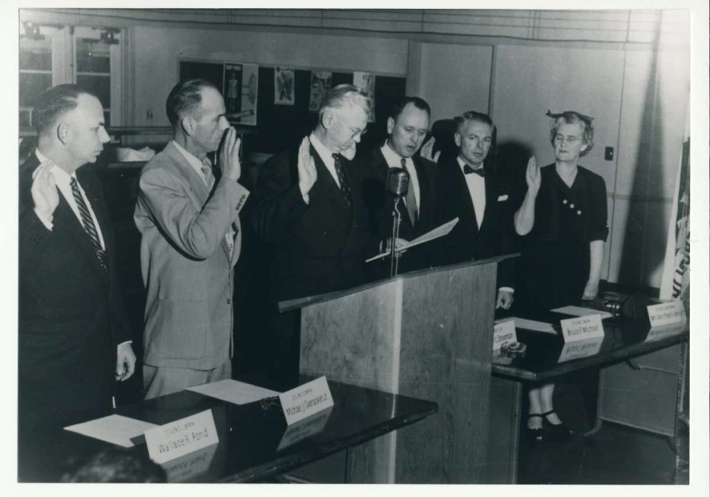 Fremont’s first city council, 1956 Judge Allen Norris swearing in the council (left to right) Wallace Pond, Michael Overacker, Judge Norris, Jack Stevenson, Bruce Michael, Winifred Bendel.
Courtesy of Washington Township Museum of Local History