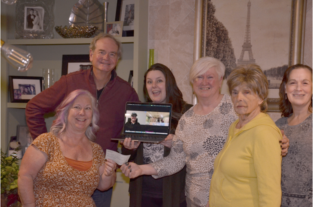 COMFORT AND JOY Adopt an Angel provides visits from Santa to children in need. (Thomas Sharp presents a check to the board.)
Photos courtesy of Thomas Sharp