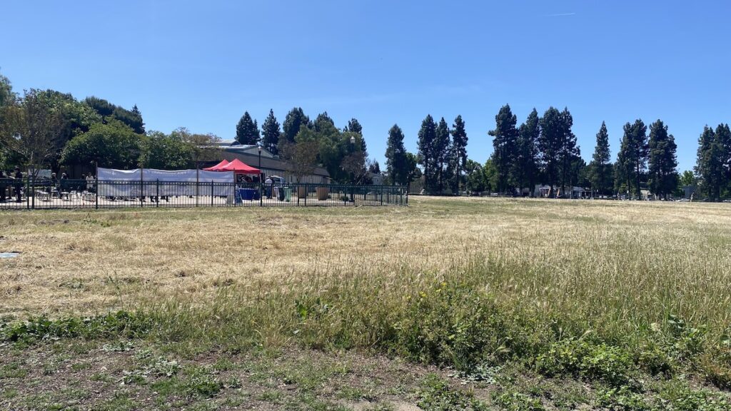 FIELD OF DREAMS The groundbreaking was held at a plaza outside the Teen Center. Just over the fence, a field of dry grass was fenced off in preparation for the work ahead. Stephanie Uchida