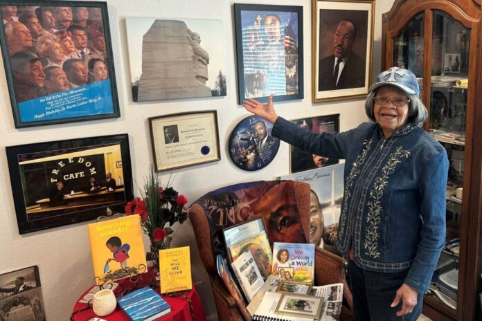 LIVING HISTORY Jean Ficklin stands next to part of her African American History Collection. Courtesy of Eve Marie Little