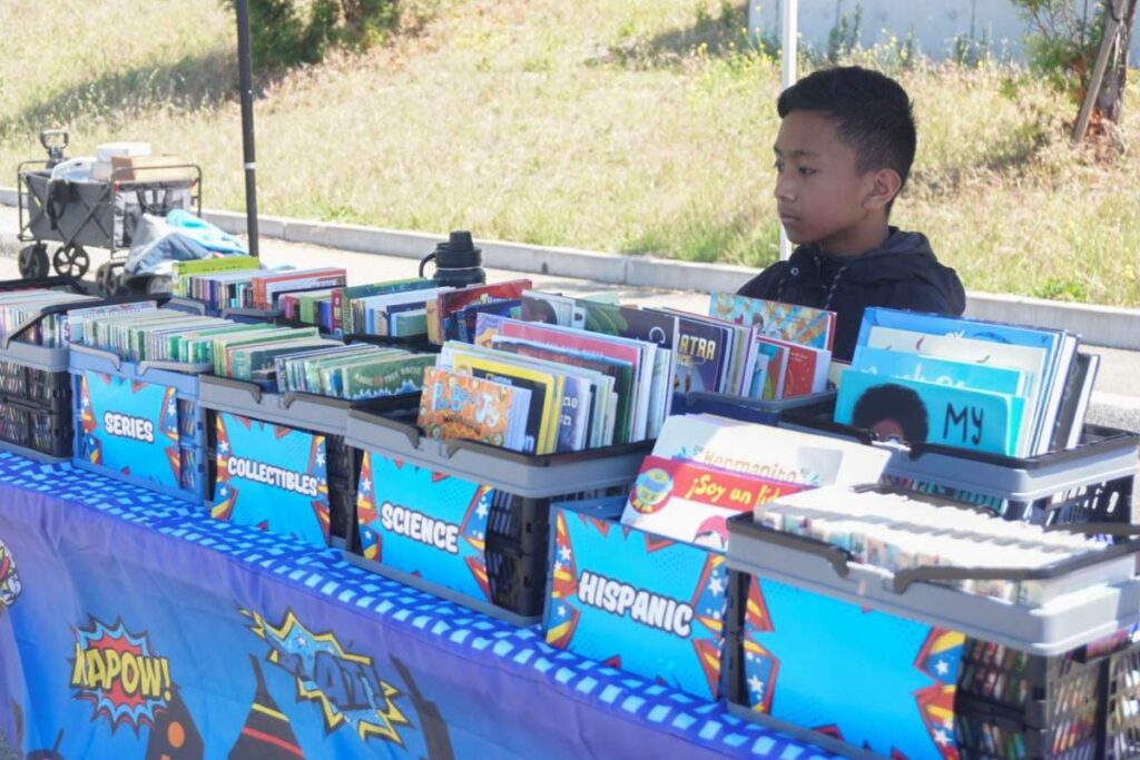 NOVEL ENDEAVOR Seventh grader Reese Romano participates as a youth vendor selling comic books, graphic novels and board games. 
Photos by Sophie Luo